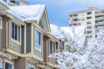 The top of a typical american home in winter. Snow covered roof and nice window.