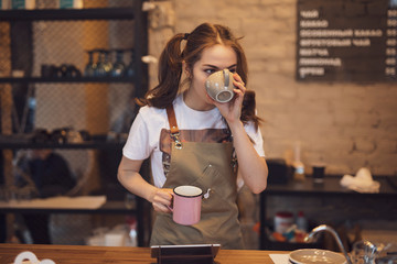 Barista woman testing taste of brewed coffee in the cafeteria