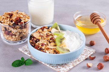 Delicious healthy Breakfast. Smoothie bowl with granola, bananas, kiwi and nuts.