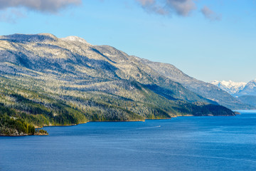 Fantastic view over ocean, snow mountain and rocks at Sechelt inlet in Vancouver, Canada.