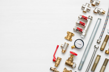 Plumbing flat lay concept background with copy space. Various water system accessories on white background.