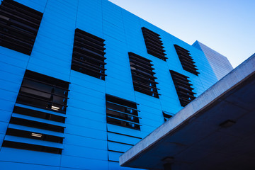 Industrial office building in simple and simple style with smooth walls, blue background and copy...