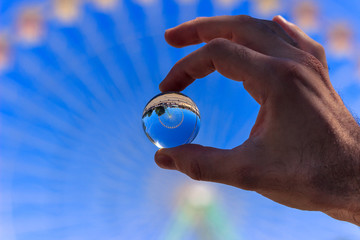 Ferris wheel in a crystal ball. Selective focus.