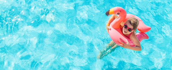 the child swims and dives in the pool. Selective focus.