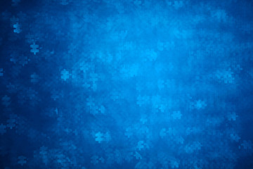Blue Puzzle shape bokeh. Defocused background for autism awareness day. Real photo. Light blue - obrazy, fototapety, plakaty