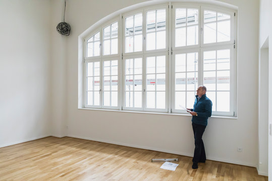 Man checking specifications of refurbished kuxury loft