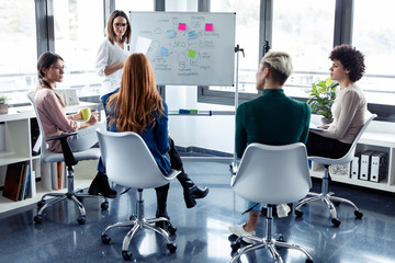 Businesswomen during meeting at a flipchart, presenting ideas for a search engine optimisation