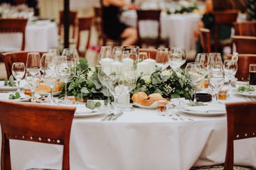 Coziness and style. Modern event design. Table setting at wedding reception.