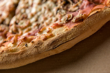 Freshly baked pizza on the cardboard