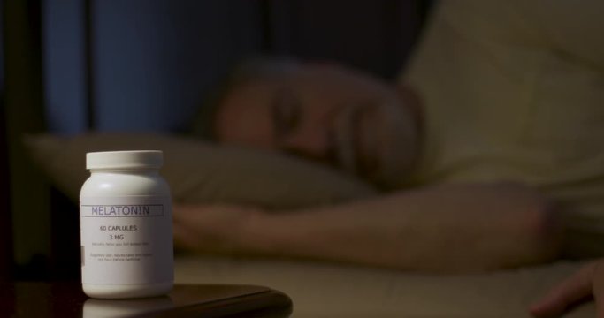 A mature man who used Melatonin to get to sleep enjoys a restful night.