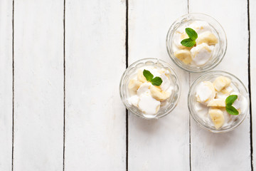 Banana with sour cream on white background