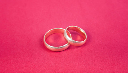 wedding rings on red background