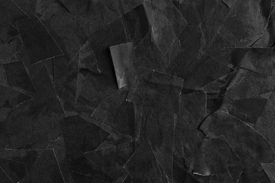 Glued pieces of black paper close-up. Texture for design.