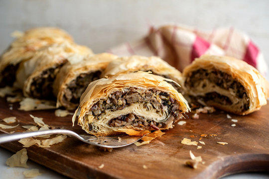 Close up of mushroom and wild rice strudel on cutting board