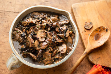 Close up of mushroom ragout served in bowl on table