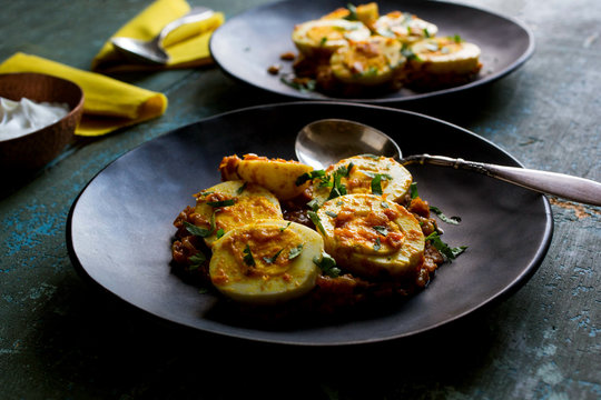 Tilt shift view of eggs in spicy tomato sauce
