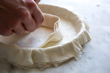 Man preparing phyllo sheets