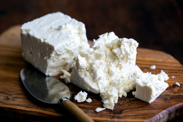 Feta cheese placed on wooden board