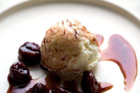 Close up view of ice cream with roasted grapes