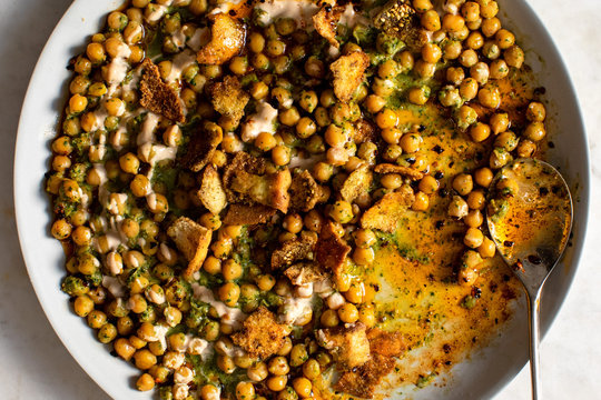 Close up view of chickpea and herb fatteh served in bowl