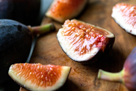 Close up view of sliced fig on wooden board