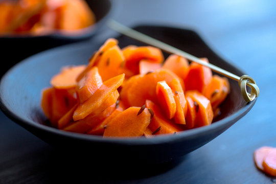 Close up of pickled carrots  with caraway seed served in bowl