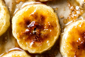 Close up view of caramelized banana slices with sugar crystals