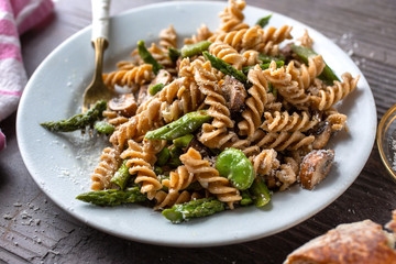 Close up of whole grain pasta with mushrooms served on plate