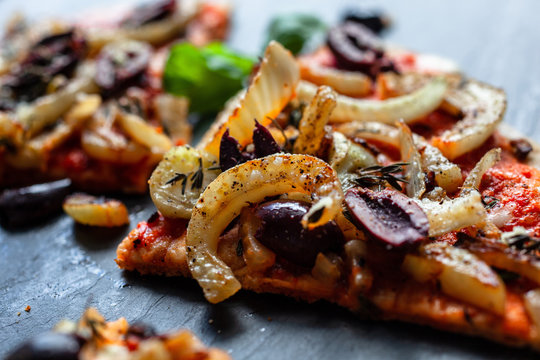 Sliced pizza with olives and grilled fennel