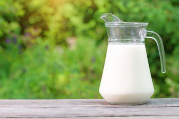 Jug of milk on a wooden table