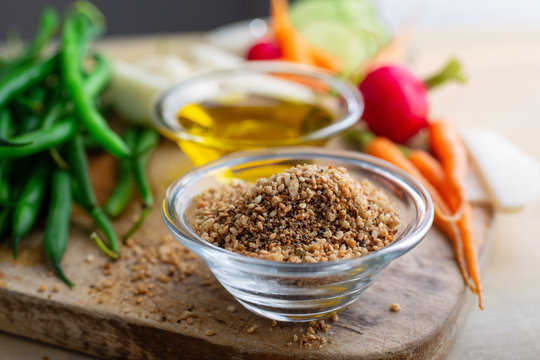 Selective focus of peanut dukkah with crudite in bowl