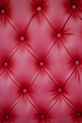 Fototapeta na wymiar Vertical background of red leather furniture upholstery