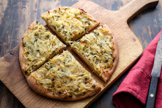 Close up view of focaccia pizza served on wooden board