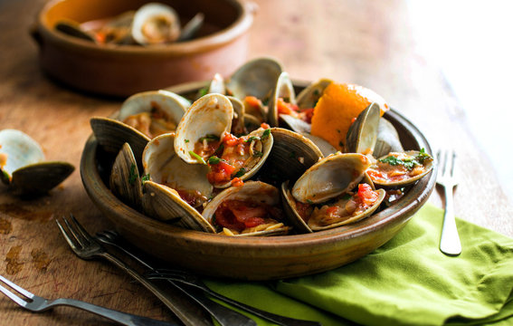 Close up view of steamed clams served in bowl