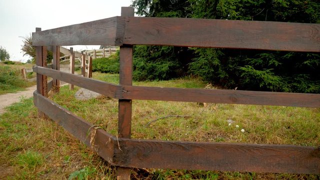 4k video of camera slowly moving along long wooden fence at rancho