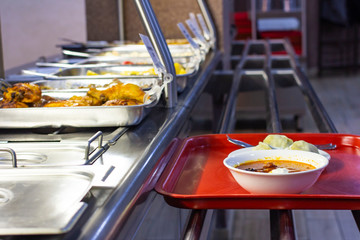 food bought in the dining room on a tray, the front and back background is blurred with a bokeh effect