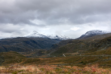 Fototapeta na wymiar Mountain snow, grass rocks peaks Norway landscape