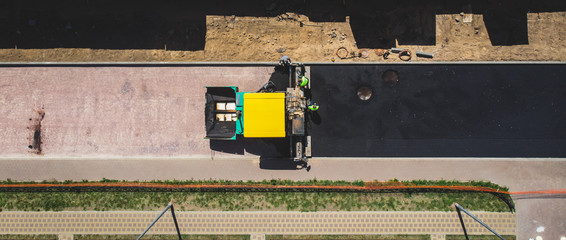 Asphalt paver machine and steam road roller during road construction and repairing works, process...