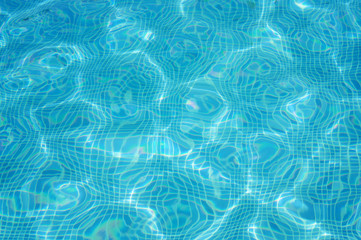 Fototapeta na wymiar Texture of blue water in swimming pool