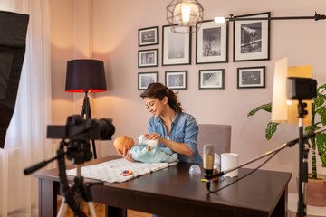 Influencer recording video about baby bottle feeding