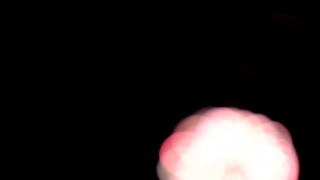 Bright colorful fireworks turn to multicolor bokeh lights at holiday dark summer night.
