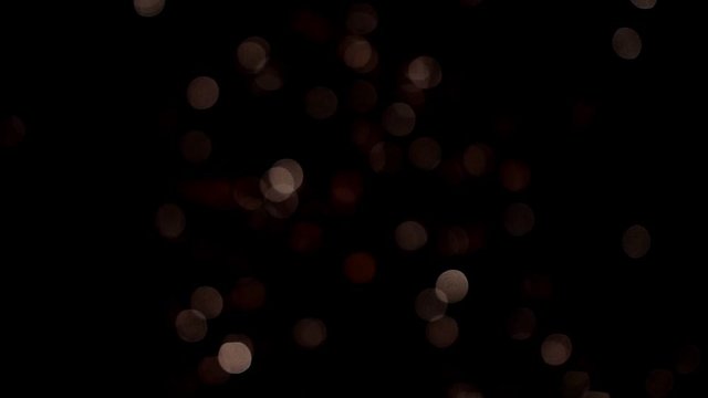 Bright colorful fireworks turn to multicolor bokeh lights at holiday dark summer night.