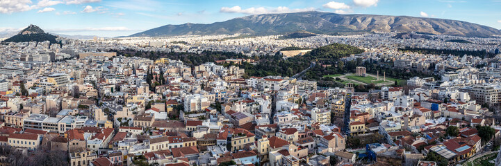 Fototapeta na wymiar Panoramic view of the Athens city with Lykavittos hill, The Greek Parliament in the center and to the far right the Temple of Olympian Zeus,