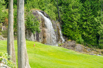 Golf course with gorgeous green and waterfall.