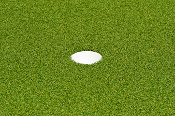 Golf hole on the green grass