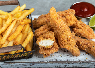 crispy fried breaded chicken breast strips french fries and sauce - 324956458