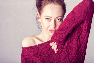 portrait of a girl in a burgundy knitted sweater