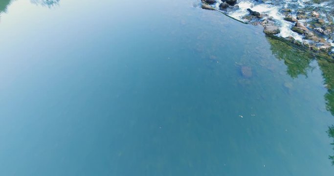 Beautiful Kolpa river in Slovenia. Aerial shot reveals raging water rapids. Aerial shot close to the water
