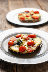 Portobello stuffed with spinach and cheese on wooden background