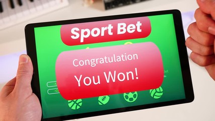 Sport betting apps on a tablet screen showing a winning message to the player.